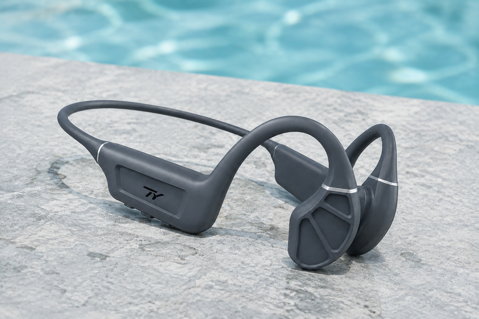 Graphite TY headset beside clear blue pool water
